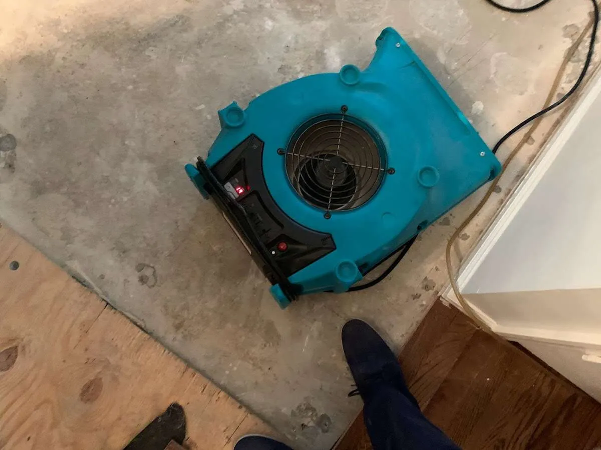 Air mover drying subfloor during Commercial Water Damage Restoration in Abingdon
